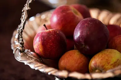 a bowl of apples in a basket at Ridgeworth Cottage in Greyton