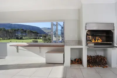 a kitchen with a stove with a fire oven at 269 on Main Holiday Home in Hermanus