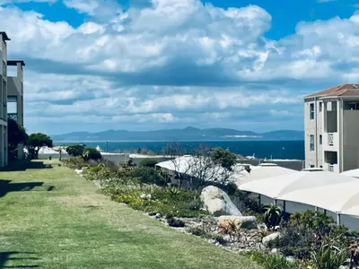 a view of the ocean from the lawn of a resort at 155 hbc in Hermanus