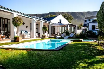 a swimming pool in the yard of a house at Sixteen Guesthouse on Main in Hermanus