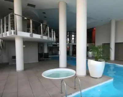 a large building with a pool and a table in the middle at Home relaxation in the city in Cape Town