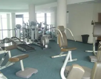 a gym with several treadmills and exercise bikes at Home relaxation in the city in Cape Town
