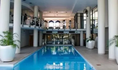 a large swimming pool in a building with columns at Home relaxation in the city in Cape Town