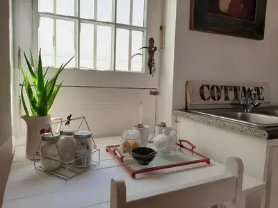 a kitchen with a counter with jars and a sink at Worcester Gallery Cottage in Worcester
