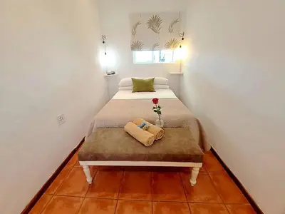 a small bedroom with a bed with a flower on it at Worcester Gallery Cottage in Worcester