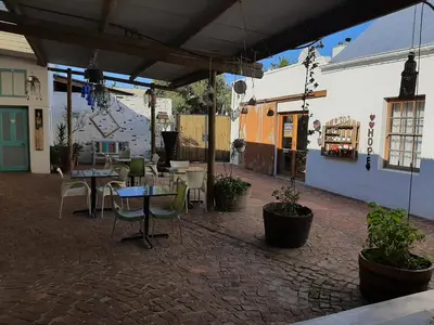 a patio with a table and chairs and a building at Worcester Gallery Cottage in Worcester