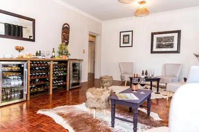 a large living room with a wine cellar at Le Petit Chateau Guest House in Durbanville