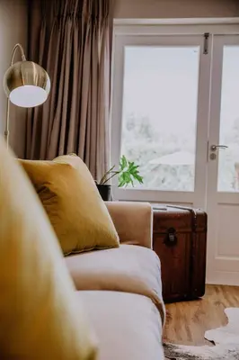 a living room with a couch and a window at Franschhoek Village House in Franschhoek