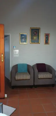 two couches sitting next to each other in a room at Dawn's Place in Strand
