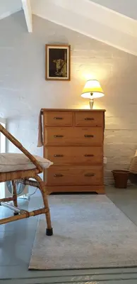 a lamp sitting on top of a dresser in a room at Dawn's Place in Strand