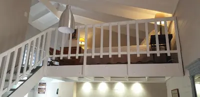 a white staircase with a bed in a room at Dawn's Place in Strand