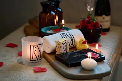 a table with a candle and towels and a toy duck at Rainbow Residence in Franschhoek