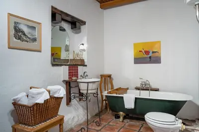 a bathroom with a green tub and a sink at Oude Wellington Estate in Wellington