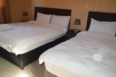 two beds sitting next to each other in a bedroom at ST@Y-1-BnB in Cape Town