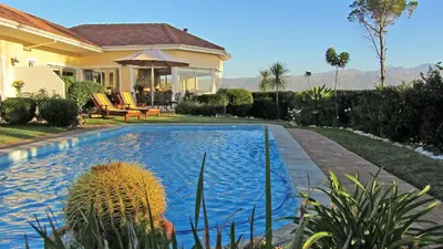 a house with a swimming pool in the yard at Somerset Sights B&B in Somerset West