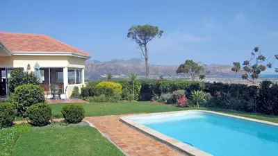 a house with a swimming pool in a yard at Somerset Sights B&B in Somerset West