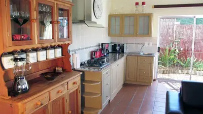 a kitchen with a stove and a counter top at Somerset Sights B&B in Somerset West