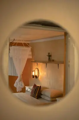 a view of a bedroom with a bed and a mirror at Southern Yurts in Botrivier