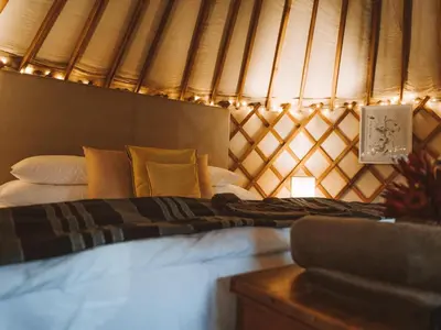 a bedroom with a bed in a tent at Southern Yurts in Botrivier