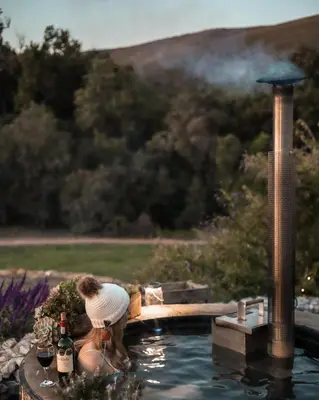 a woman is standing in a pool of water at Southern Yurts in Botrivier