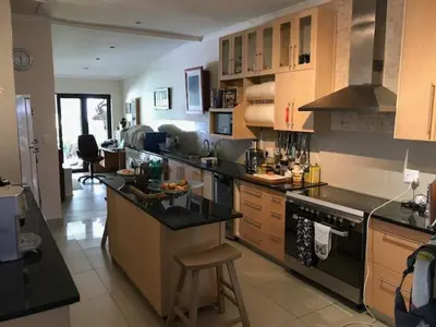 a kitchen with a stove and a counter top at At 27 on Derby in Cape Town