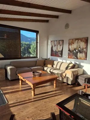 a living room with a couch and a coffee table at Arbeidsgenot Beach House in Hermanus