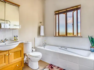 a bathroom with a tub and a toilet and a sink at Lord's Wine Farm in McGregor