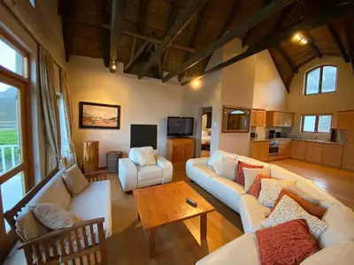 a living room with white couches and a table at Lord's Wine Farm in McGregor