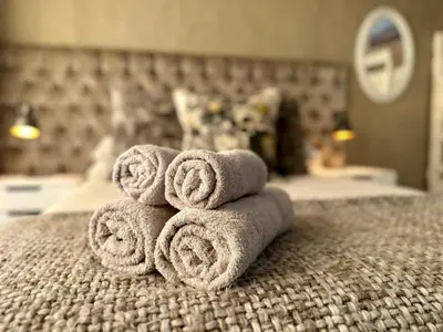 a pile of towels sitting on top of a bed at the STUDIO apartment in Durbanville in Durbanville