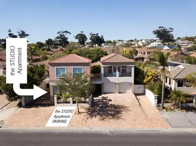 a house with a sign that says the studio international building at the STUDIO apartment in Durbanville in Durbanville