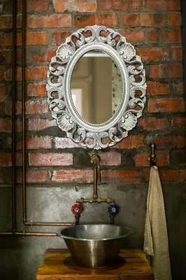 a bathroom sink with a mirror on a brick wall at the STUDIO apartment in Durbanville in Durbanville