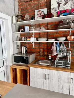 a kitchen with a sink and a brick wall at the STUDIO apartment in Durbanville in Durbanville
