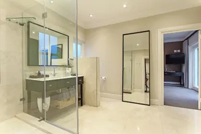 a bathroom with a sink and a glass shower at Stellenbosch Manor in Stellenbosch