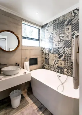 a bathroom with a tub and a sink at Serendipity in Hermanus