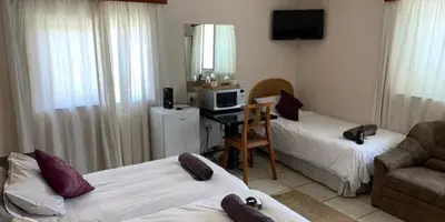 a living room with two beds and a couch at Lodge Strand (The) in Strand