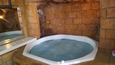 a bath tub with a blue water inside of it at Lodge Strand (The) in Strand