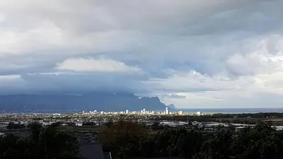 a view of a city with a mountain in the background at Bay View Guest House in Somerset West