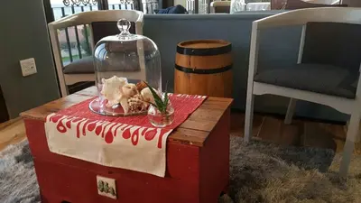 a table with a plate of food on top of it at Bay View Guest House in Somerset West