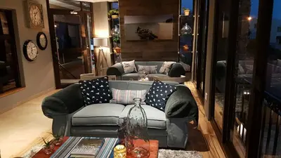 a living room with a couch and a table at Bay View Guest House in Somerset West