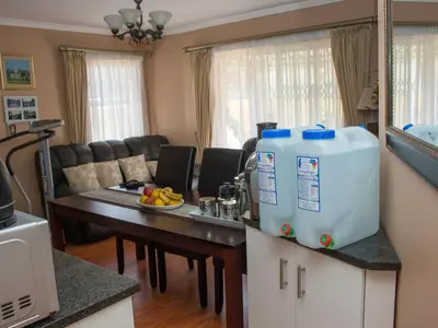 a kitchen with a table with a water cooler on it at Onyx on Sycamore in Cape Town