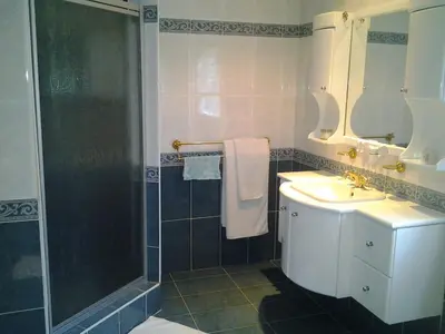 a bathroom with a sink and a shower at Annette Guesthouse in Plattekloof