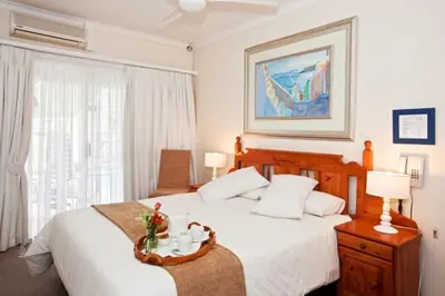 a hotel room with a bed and a window at Annette Guesthouse in Plattekloof