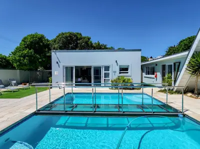a swimming pool in the backyard of a house at Salt Boutique Guest House in Bloubergstrand