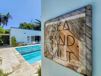 a house with a sign that says sea saved me at Salt Boutique Guest House in Bloubergstrand