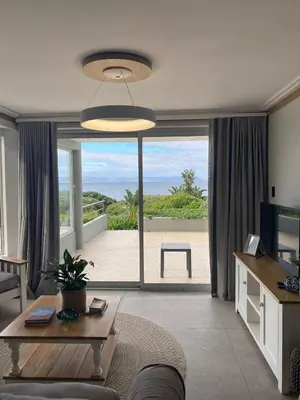 a living room with a view of the beach at Bayview 104 in Hermanus
