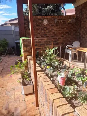 a garden in a brick wall with plants at On Yonder Hill in Cape Town
