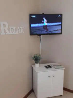 a flat screen tv on a wall in a room at On Yonder Hill in Cape Town