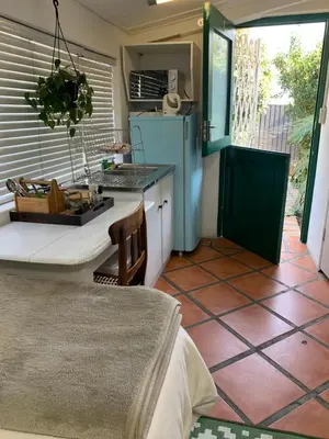 a kitchen with a table and a counter top at Just a Bed parking on street in Stellenbosch