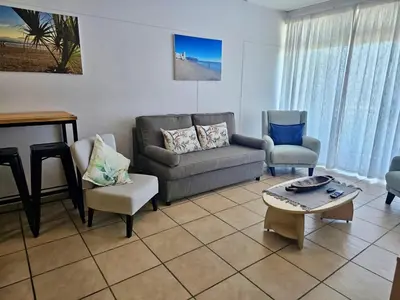 a living room with a couch and chairs and a table at C-Rus in Strand