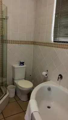 a bathroom with a toilet and a bath tub at C-Rus in Strand